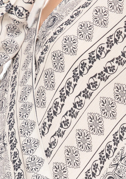 Close-up of a floral patterned fabric with navy  design on a white background.