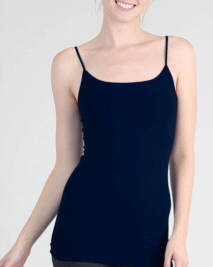 Woman wearing a navy blue camisole against a white background.