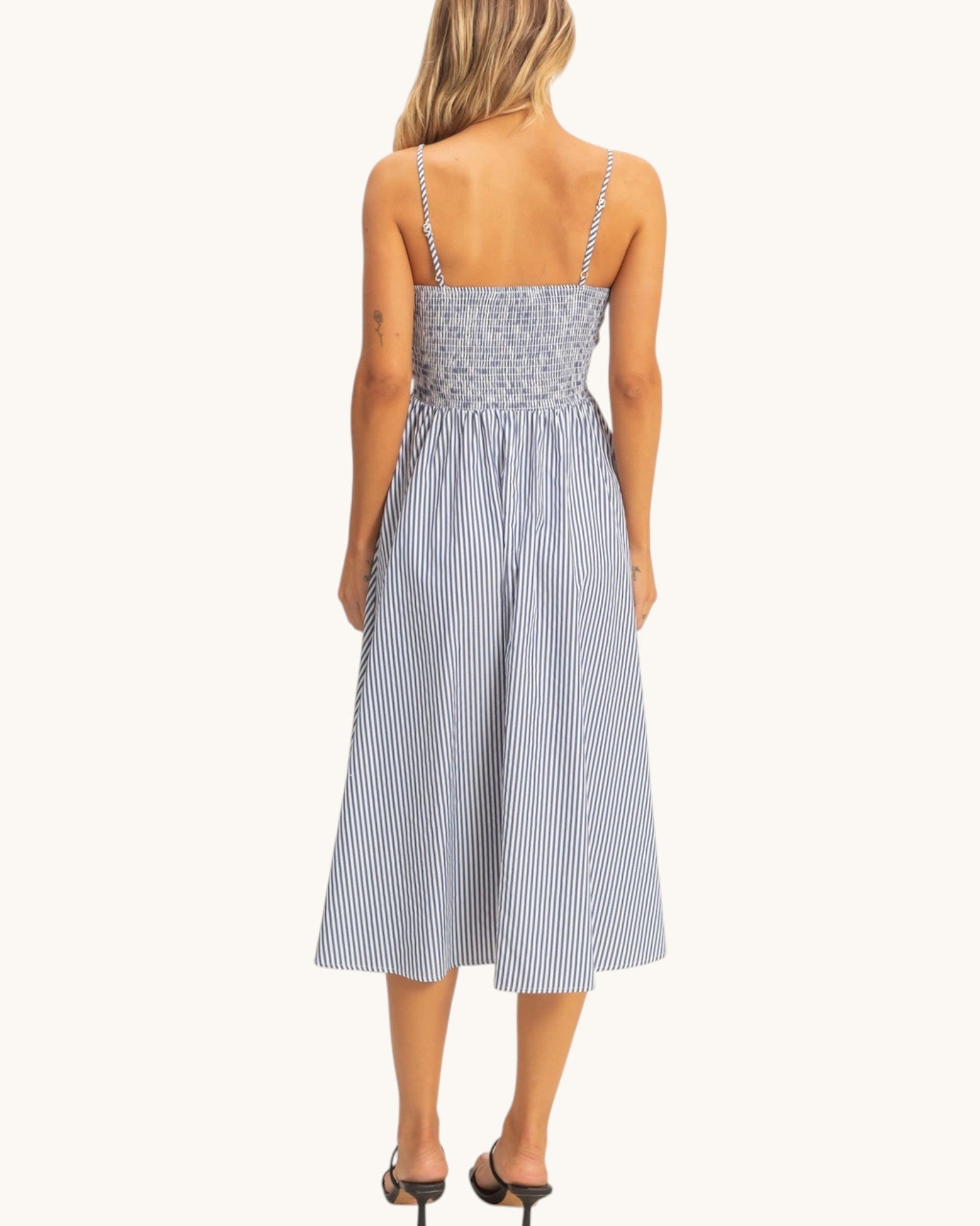 Back view of a woman the City Stroll Navy and White Striped Midi Dress.