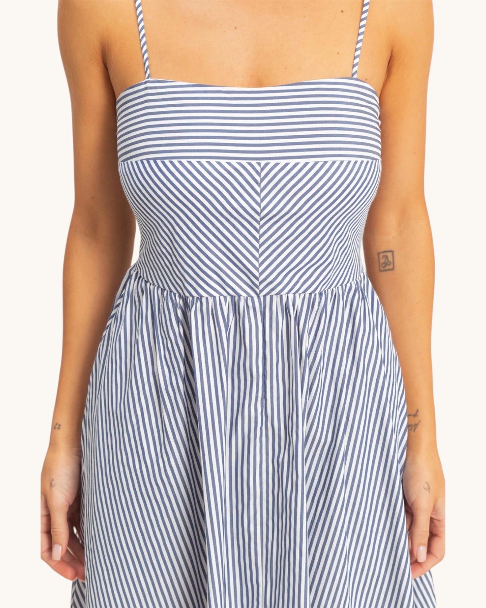 Close up view of the City Stroll Navy and White Striped Midi Dress.