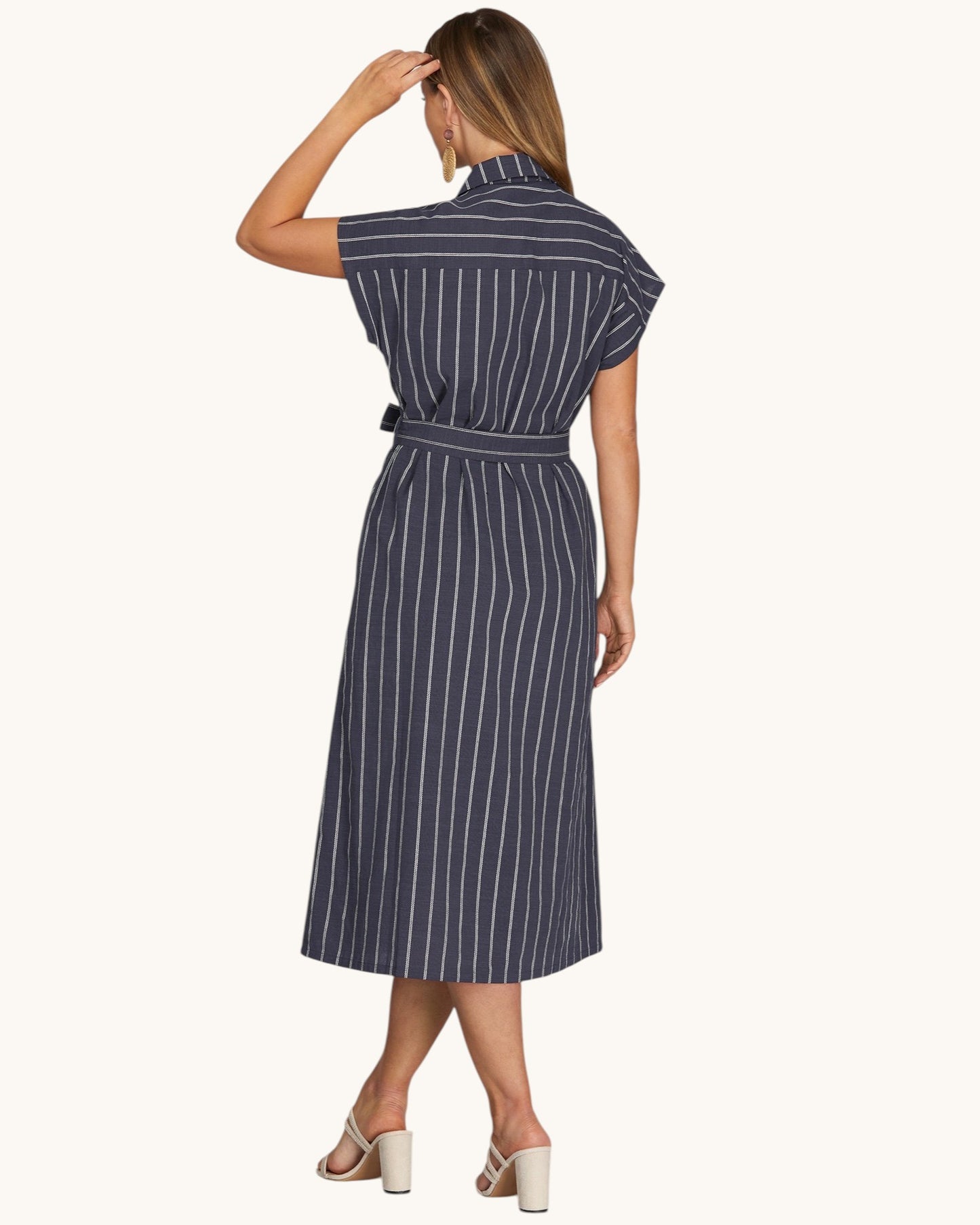 Woman modeling the back view of a classic Navy pinstripe midi shirt dress.