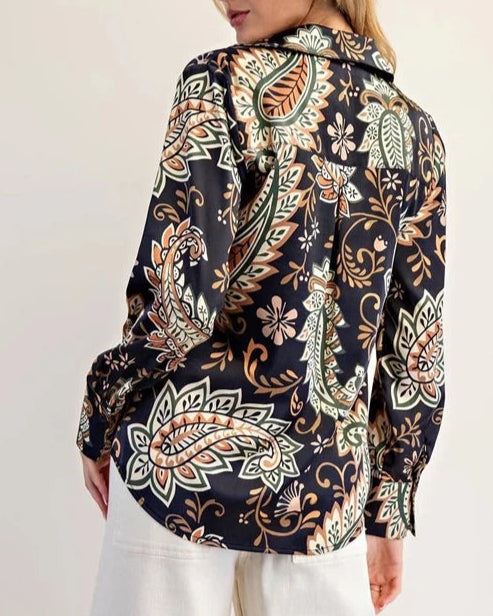Woman wearing a Navy Paisley patterned blouse with a white background.