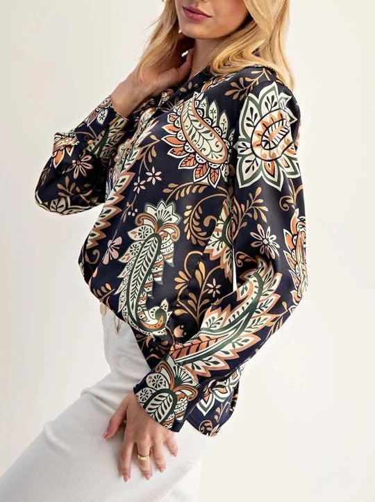 Woman wearing a Navy Paisley patterned blouse with a white background.
