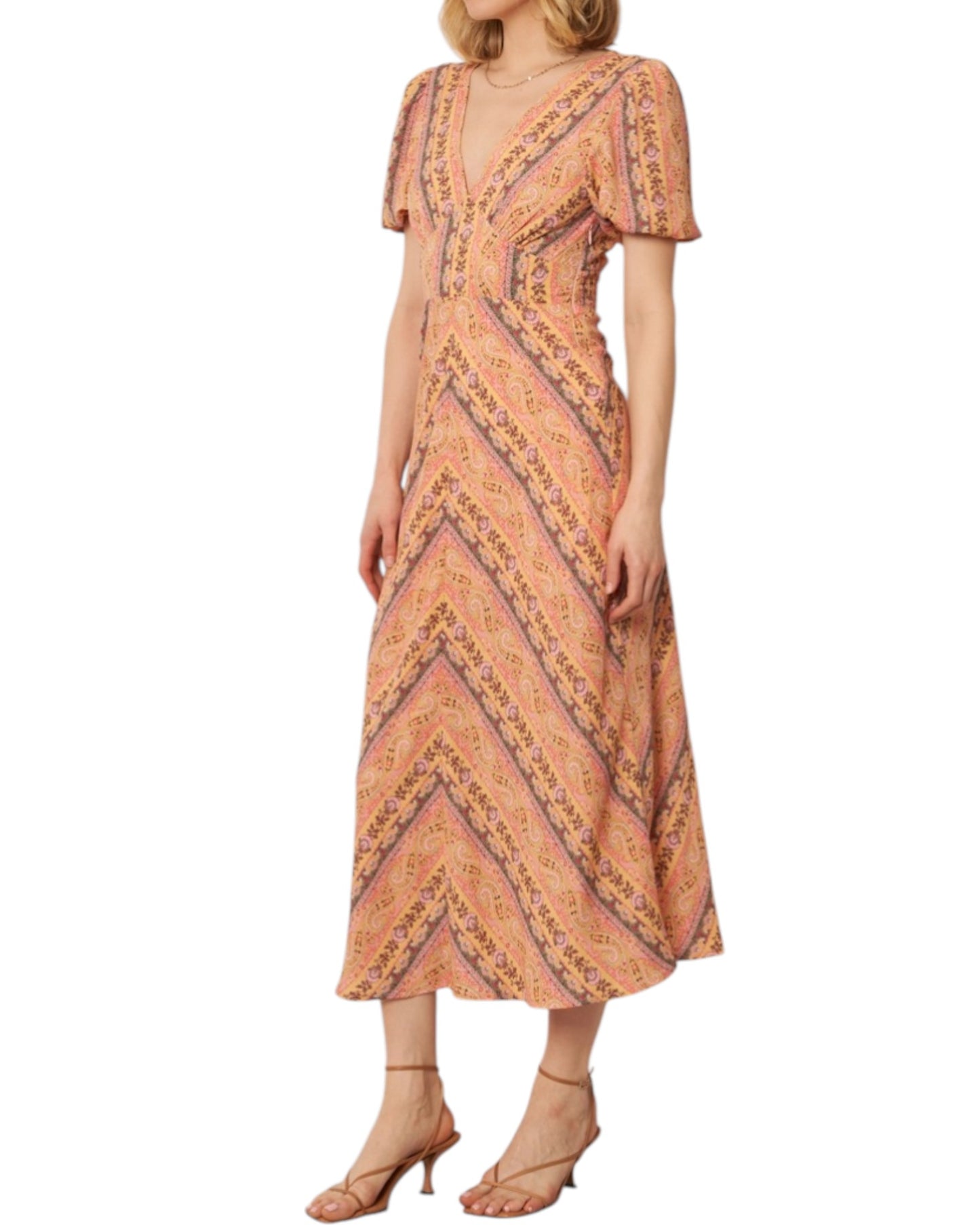 Woman wearing a soft pink paisley patterned midi dress on a white background.