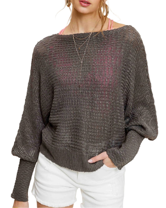 Woman wearing Pebble/Grey lightweight dolman sleeve boat neck sweater with exposed seams.