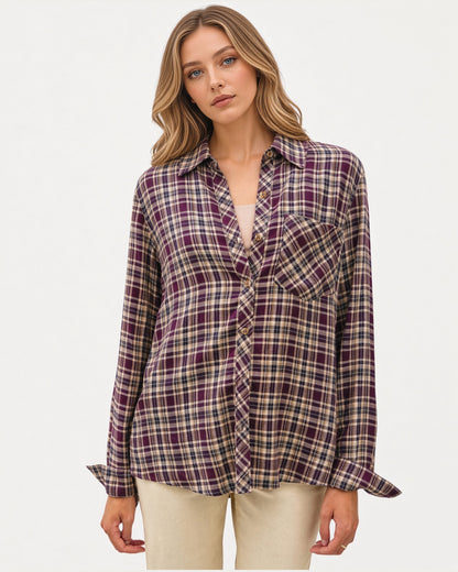 Model wearing a mixed plum plaid button down long sleeve top with a relaxed fit, cuffs and classic collar. 