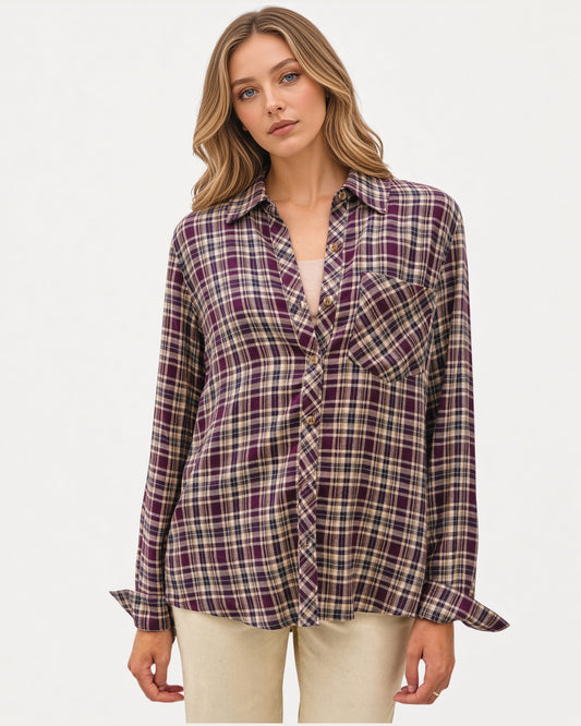 Model wearing a mixed plum plaid button down long sleeve top with a relaxed fit, cuffs and classic collar. 