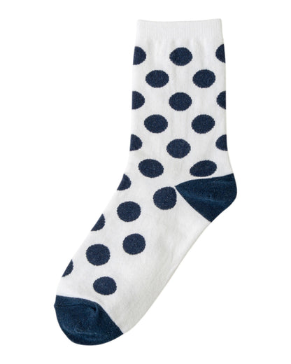 White sock with navy blue polka dots on a white background.