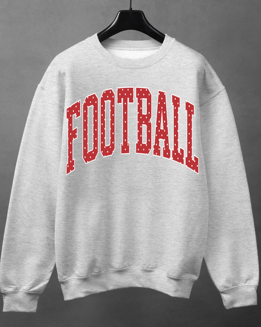 Light heather gray crewneck sweatshirt with red varsity-style FOOTBALL lettering and white polka dots.