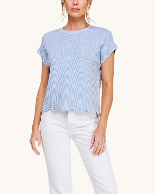 Powder Blue short sleeve top with delicate wave pattern paired with white denim. 