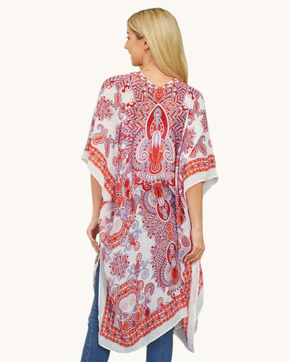 Back view of a woman wearing a red and white patterned kimono-style wrap/cover up on a white background.