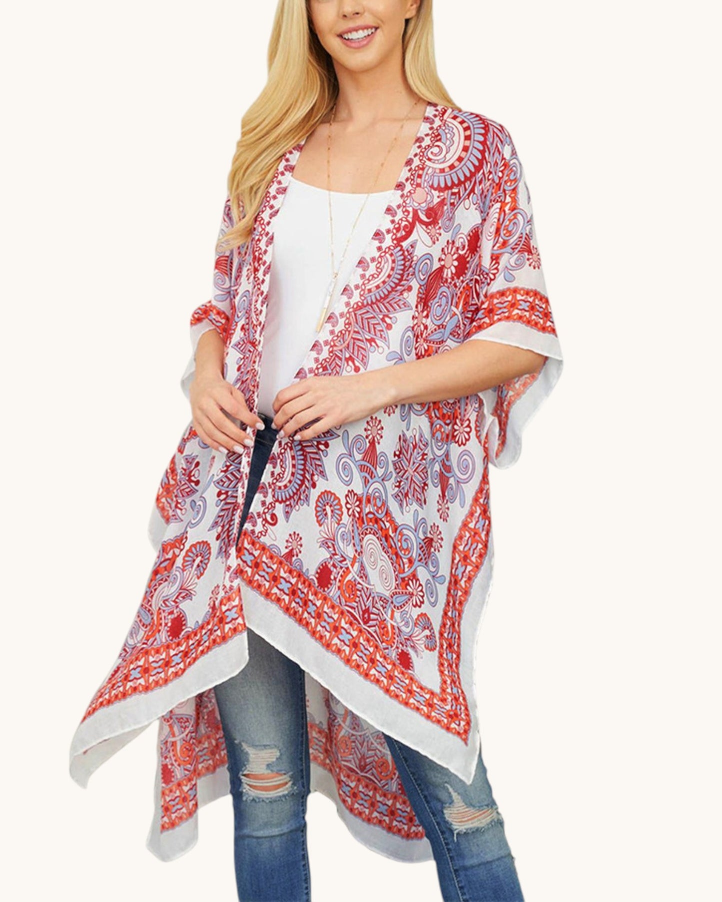 Woman wearing a red and white patterned kimono over a white top and blue jeans on a white background.