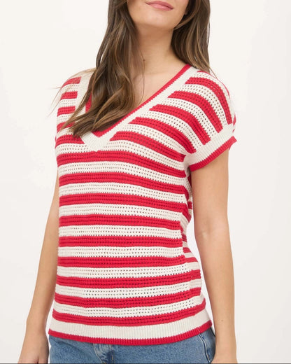 Woman wearing a red and cream V neck crochet short sleeve sweater with relaxed fit.