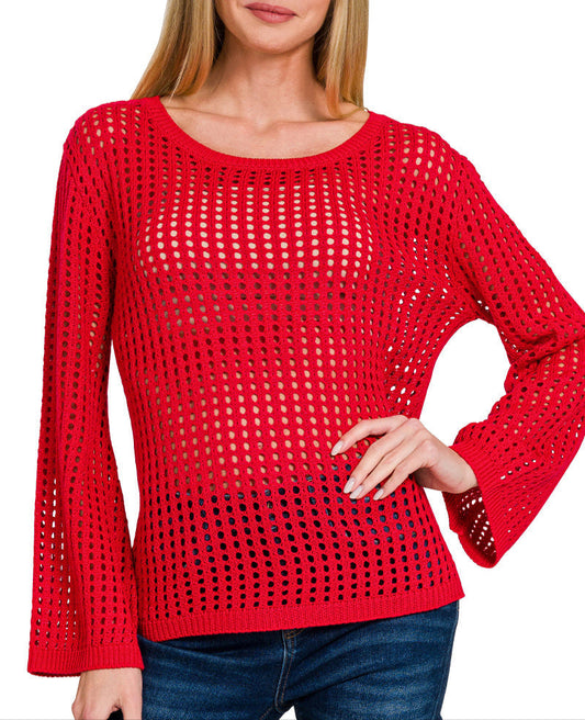 Woman wearing bold red open knit long sleeve top with flare sleeves and scoop neckline. 