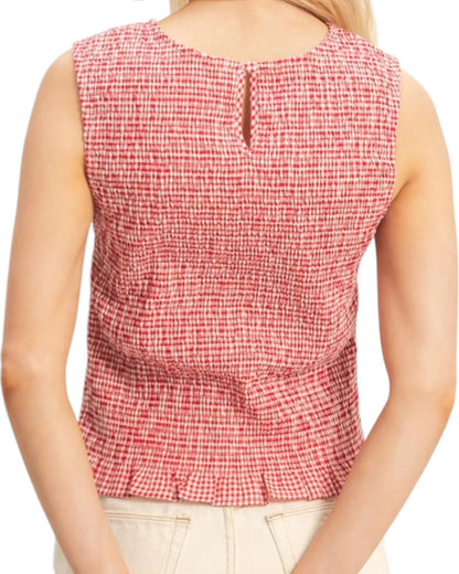 Red and white checkered sleeveless top worn by a person on a white background.