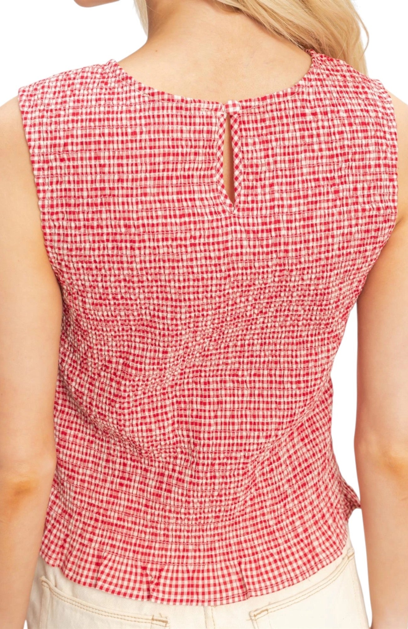 Back of a Red and white checkered sleeveless top worn by a person on a white background.