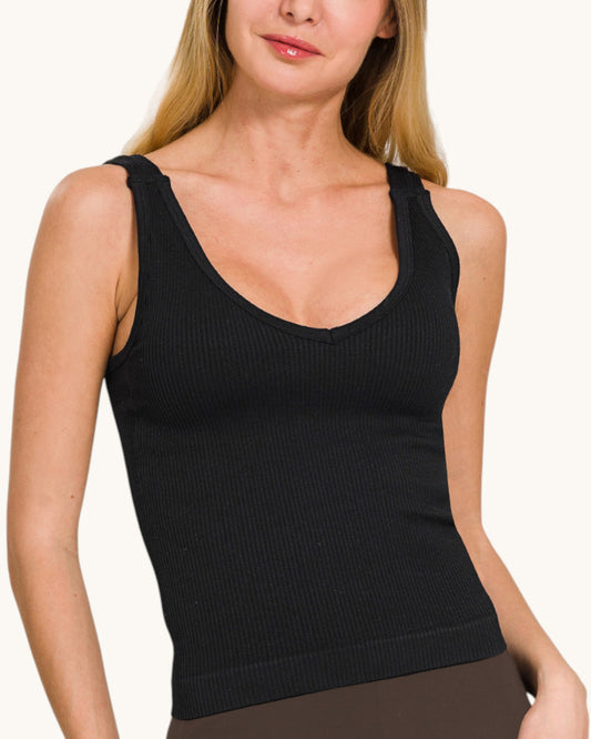 Woman wearing a black ribbed tank top against a white background.