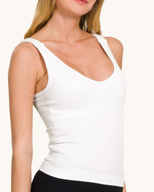 Woman wearing a ribbed white tank top.