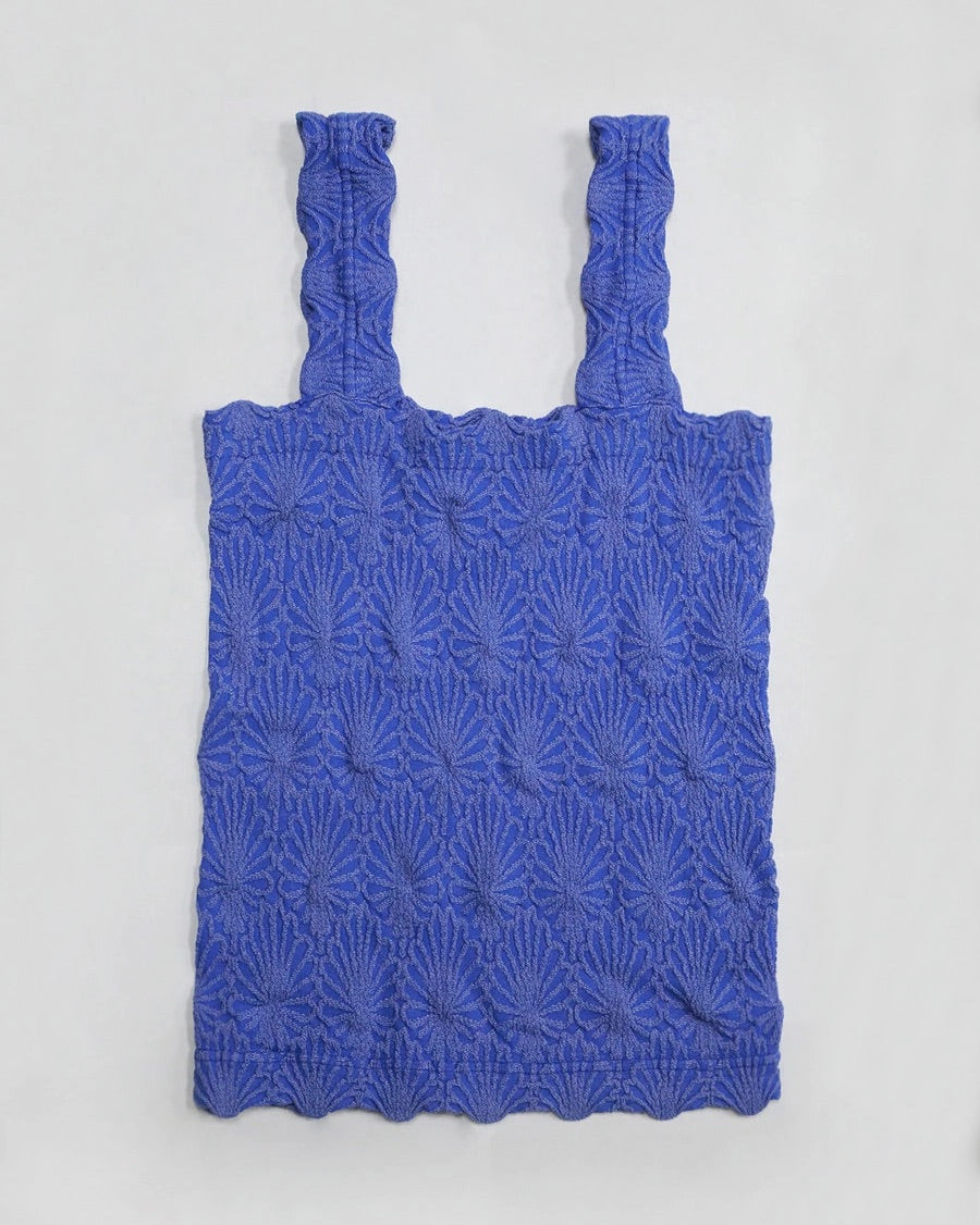 Blue floral textured tank top on a light gray background.