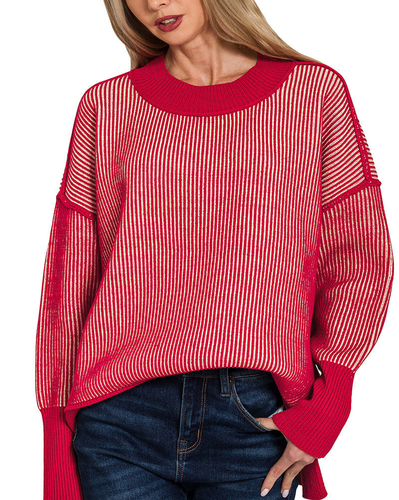 Woman wearing a red and white striped sweater with blue jeans on a white background.