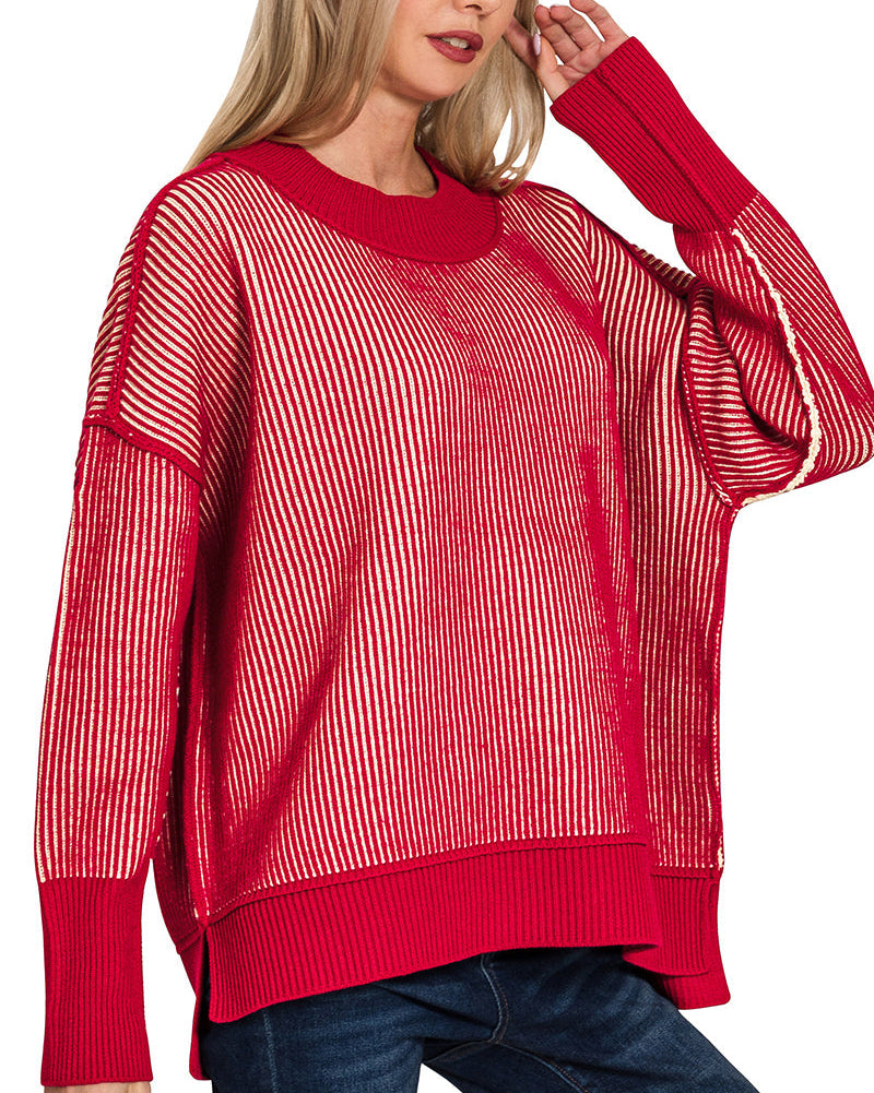 Woman wearing a red striped sweater and blue jeans on a white background.