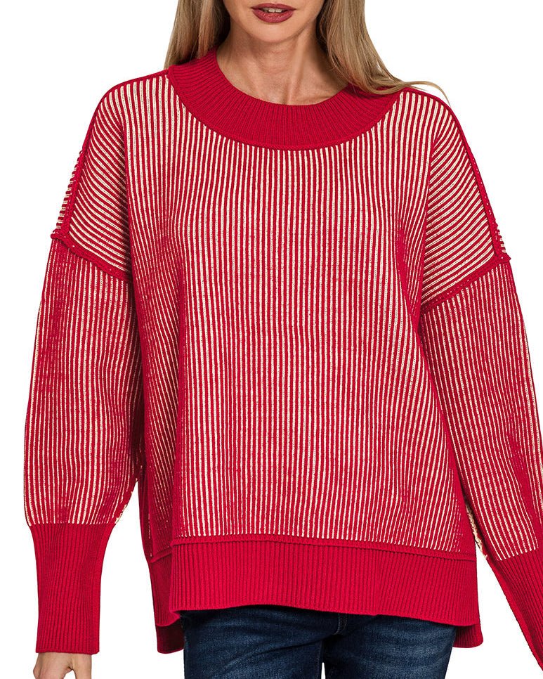 Woman wearing a red sweater with a white striped pattern on a white background.