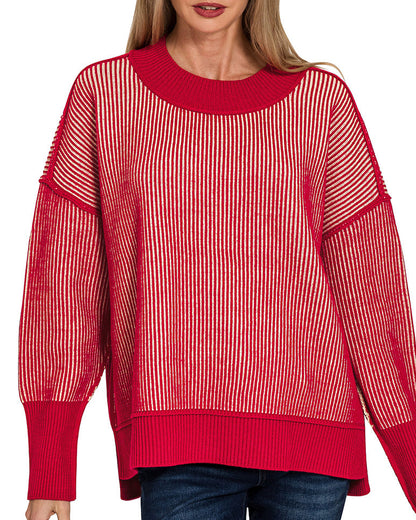 Woman wearing a red sweater with a white striped pattern on a white background.