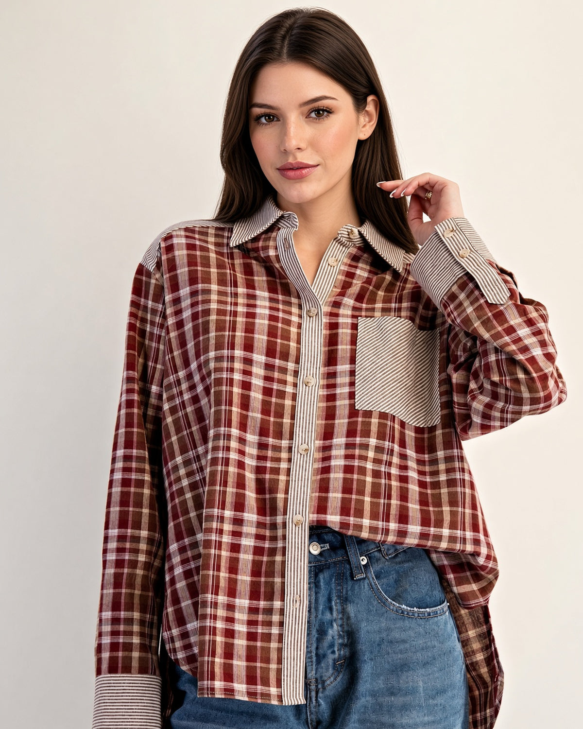 Front view of rust plaid shirt showing striped chest pocket and contrasting long sleeve cuffs.