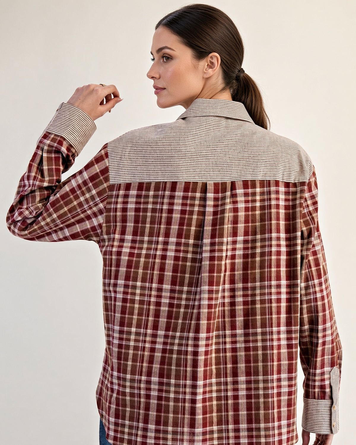Rust plaid contrast button-up on model, showing relaxed fit and curved high-low hem.