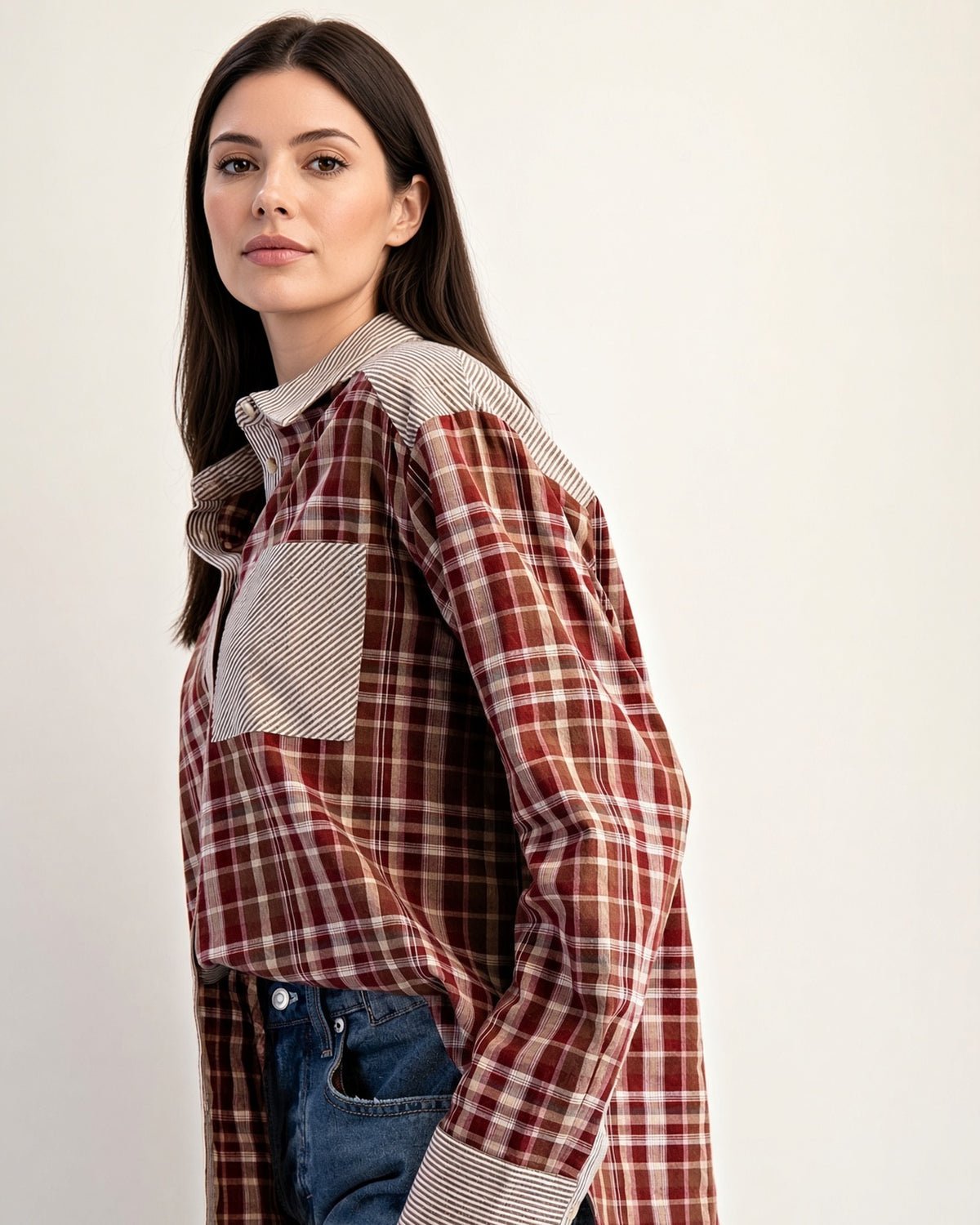 Back view of rust plaid cotton shirt showing striped back yoke and center pleat.