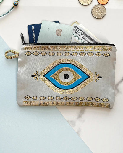 Small pouch with blue eye design on a light background.