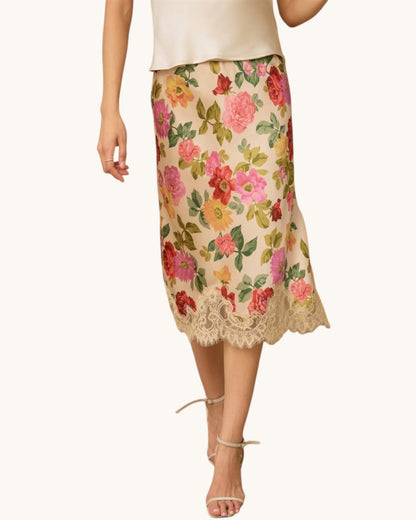 Floral skirt with lace trim worn by a person on a white background.