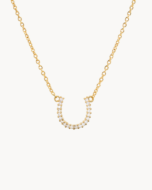 14K gold-dipped, sparkling lucky horseshoe CZ necklace with an adjustable chain.