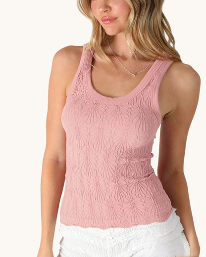 Woman wearing a pink textured tank top on a white background.