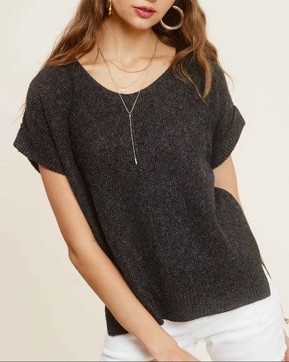 Woman wearing charcoal heather short-sleeve lightweight textured sweater with wide V-neck and side slits.