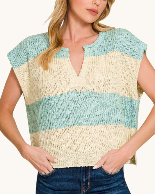 Woman wearing a sleeveless, striped top with blue and beige colors on a white background.