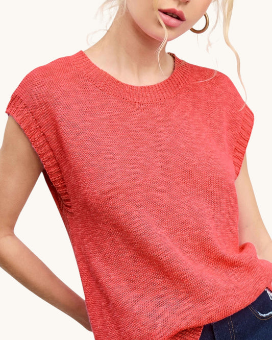 Red sleeveless top worn by a person on a white background.