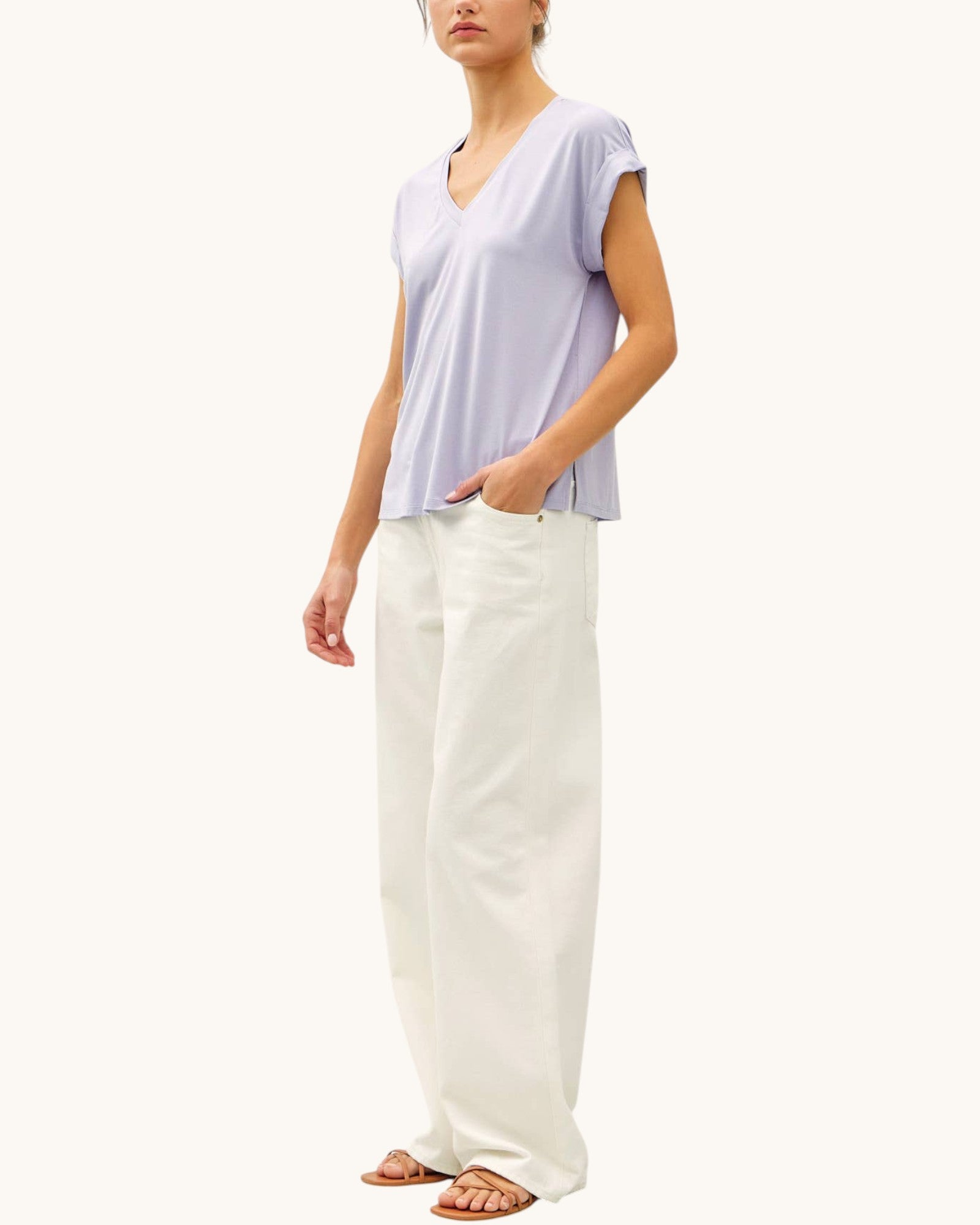 Soft modal lilac tee shirt with v-neckline paired with cream pants and sandals.