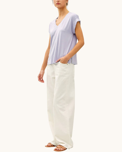 Soft modal lilac tee shirt with v-neckline paired with cream pants and sandals.