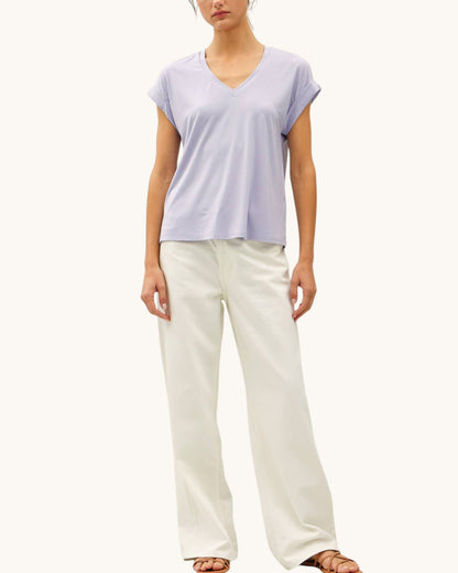 Soft modal lilac tee shirt with v-neckline paired with cream pants.