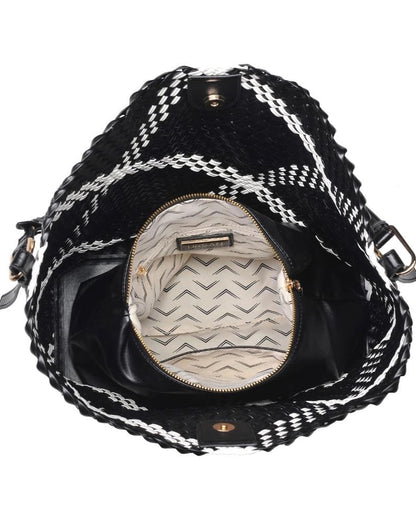 Black and white patterned handbag with open zipper showing interior.