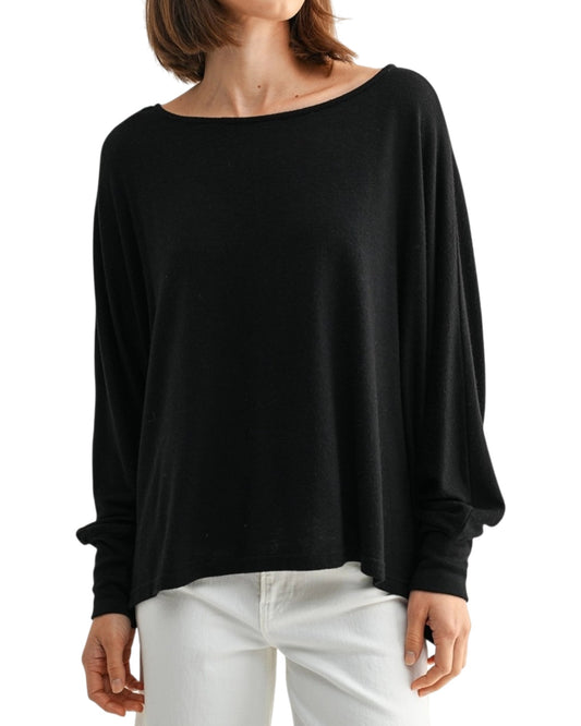 Black oversized and lightweight long sleeve top worn by a person on a white background.