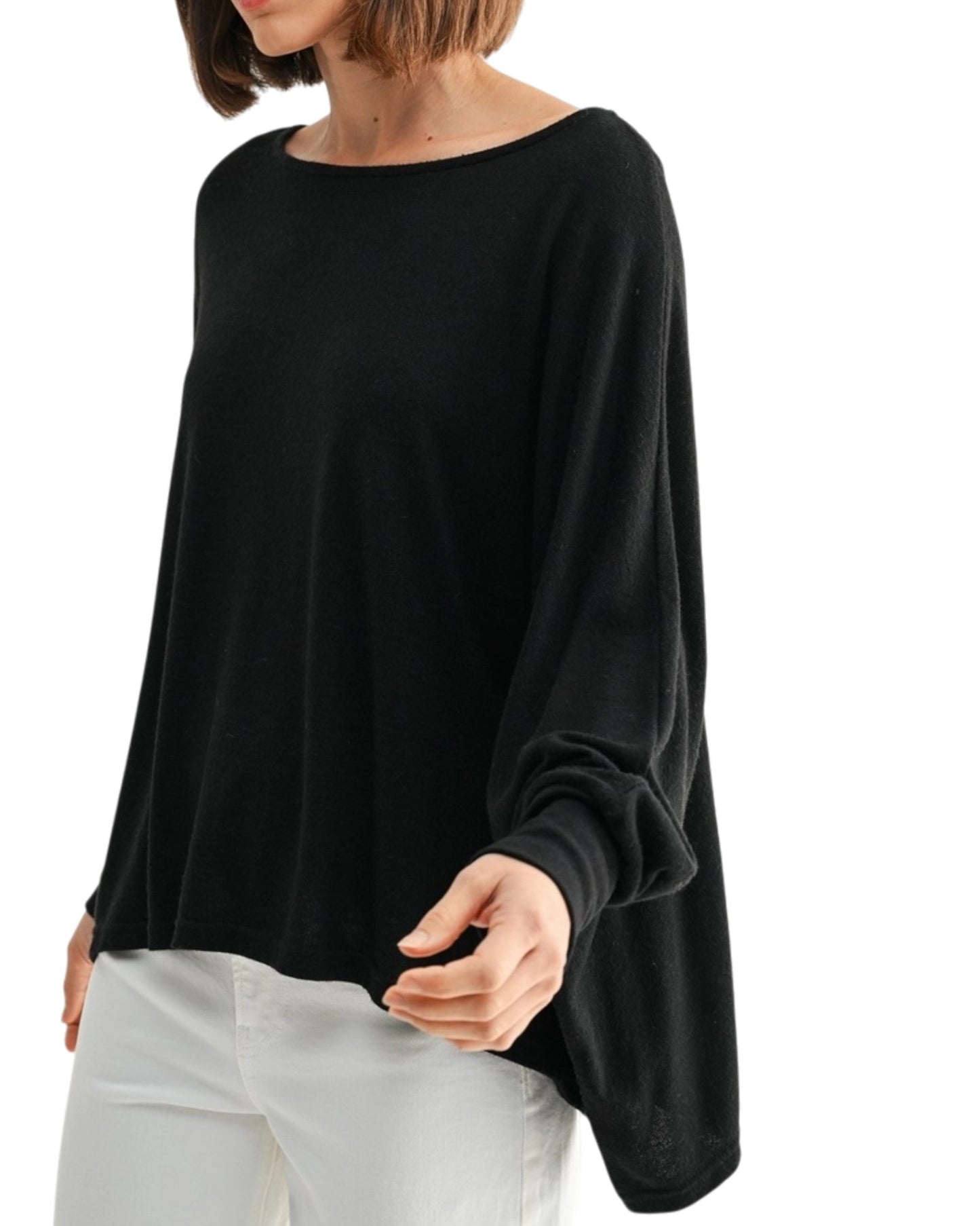 Black oversized and lightweight long sleeve top worn by a person on a white background.