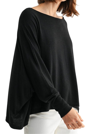 Black oversized and lightweight long sleeve top worn by a person on a white background.