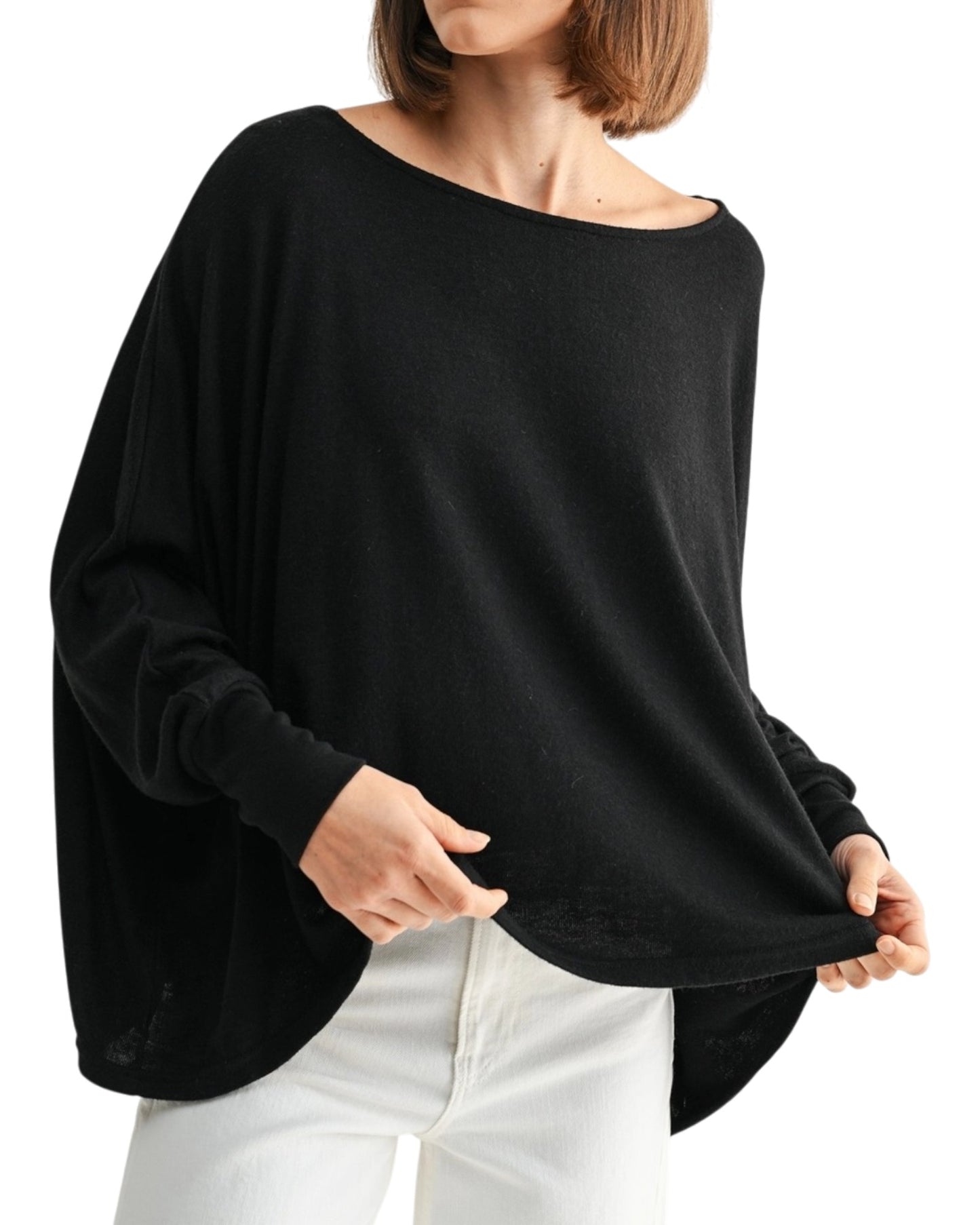Black oversized and lightweight long sleeve top worn by a person on a white background.