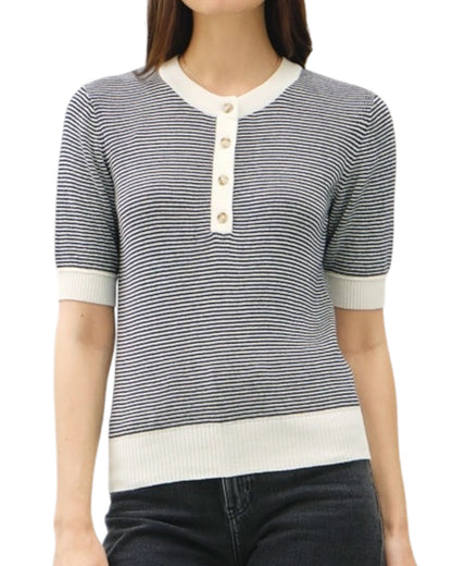 Woman wearing a navy and white striped shirt with a collar on a white background