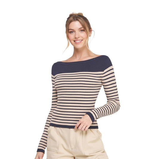 Woman wearing boat neck navy and beige striped shirt. 