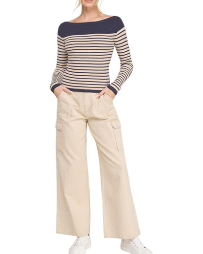 Woman wearing a navy stripe boatneck top. 