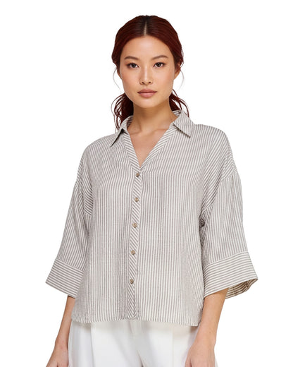 Woman wearing a striped shirt on a white background.