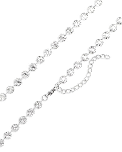 Silver starburst necklace on a white background.